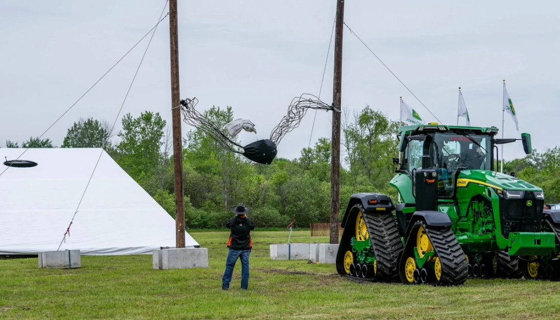 a giant cornhole game using a tractor and a slingshot