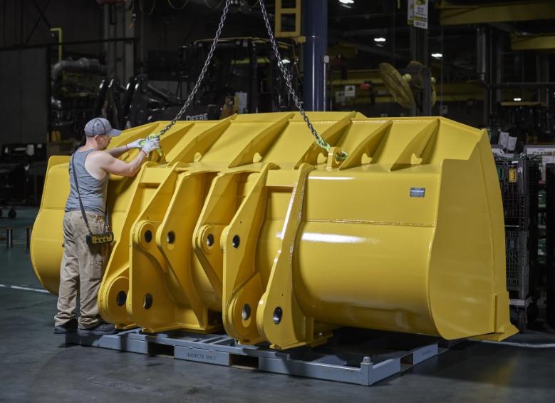John Deere yellow bucket in a factory
